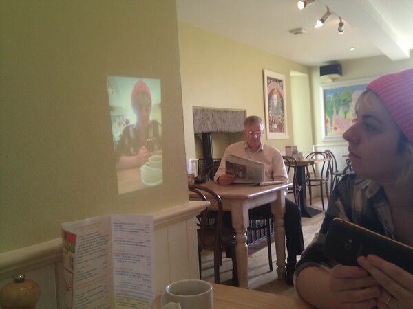 Zoe, in Designs Cafe in Castle Douglas, watching a video of herself projected onto the wall