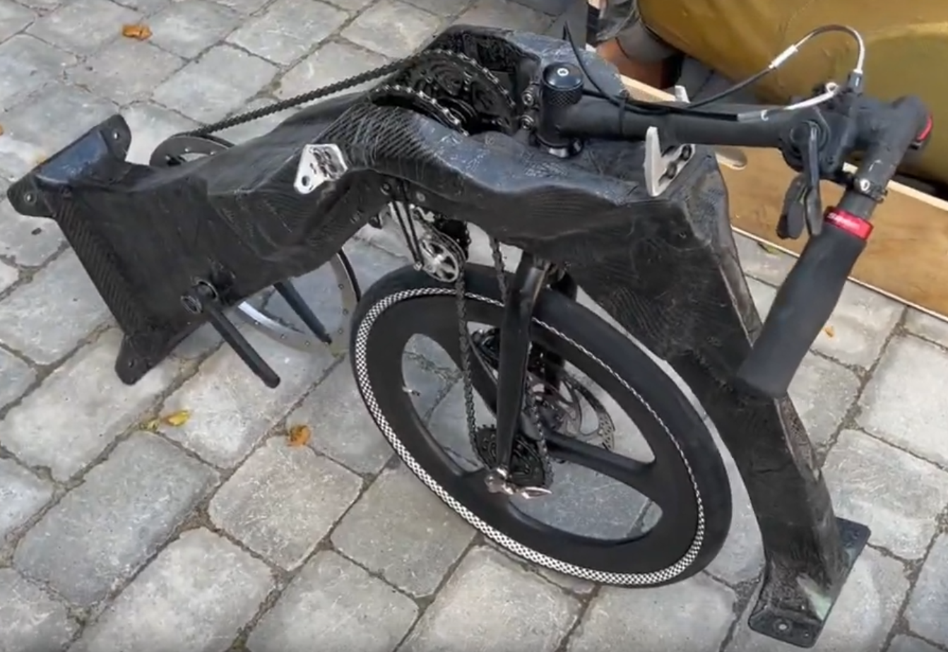 Transmission/steering sub-assembly of Seventy Seven, showing the secondary chain with its tension idler on the near (left hand) side, and the primary chain driving the cassette on the far (right hand) side. Note the very substantial overall width of the transmission in front of the steering head.
