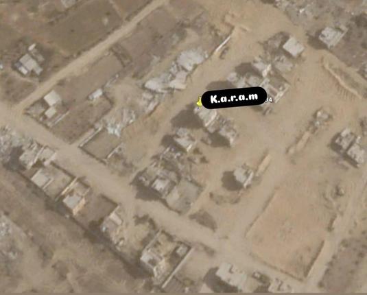 A screenshot, apparently from Google Maps, shows what seems to be an area of desert with ruins of destroyed buildings.