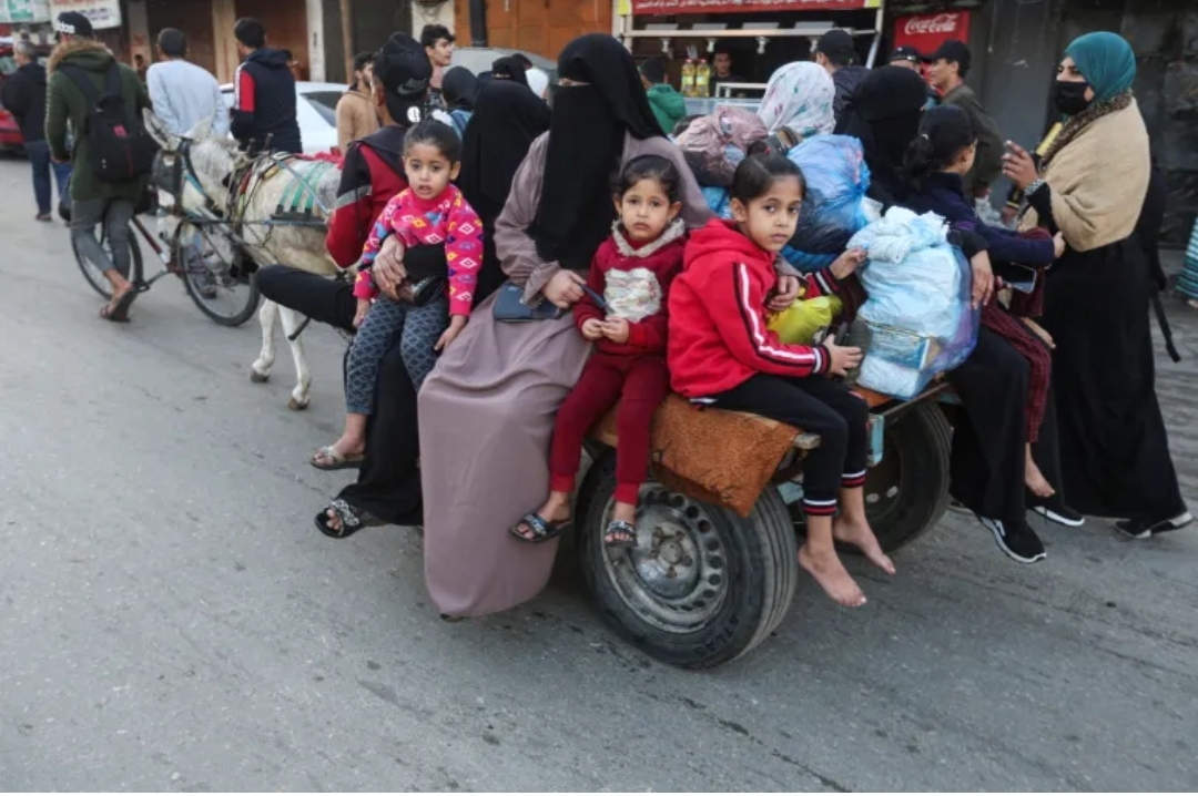 A family travelling on a cart drawn by a donkey